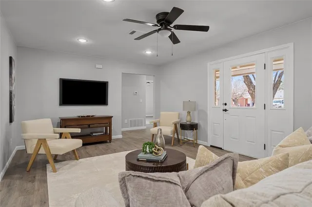 a living room with furniture and a flat screen tv