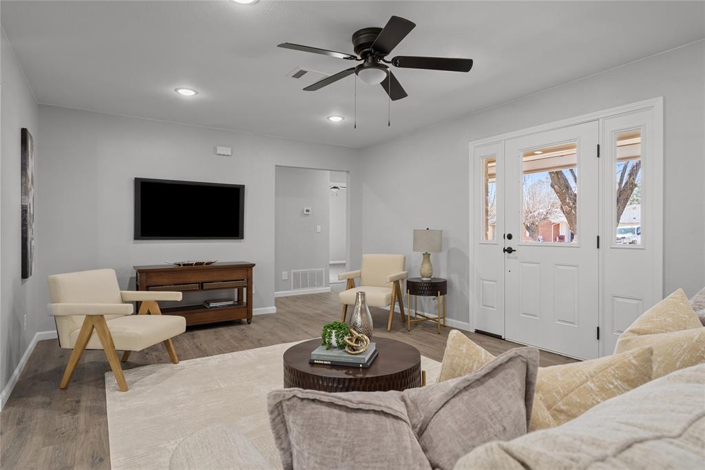 2602 Taylor Street Commerce, TX 75428 - Photo 2 of 37 a living room with furniture and a flat screen tv