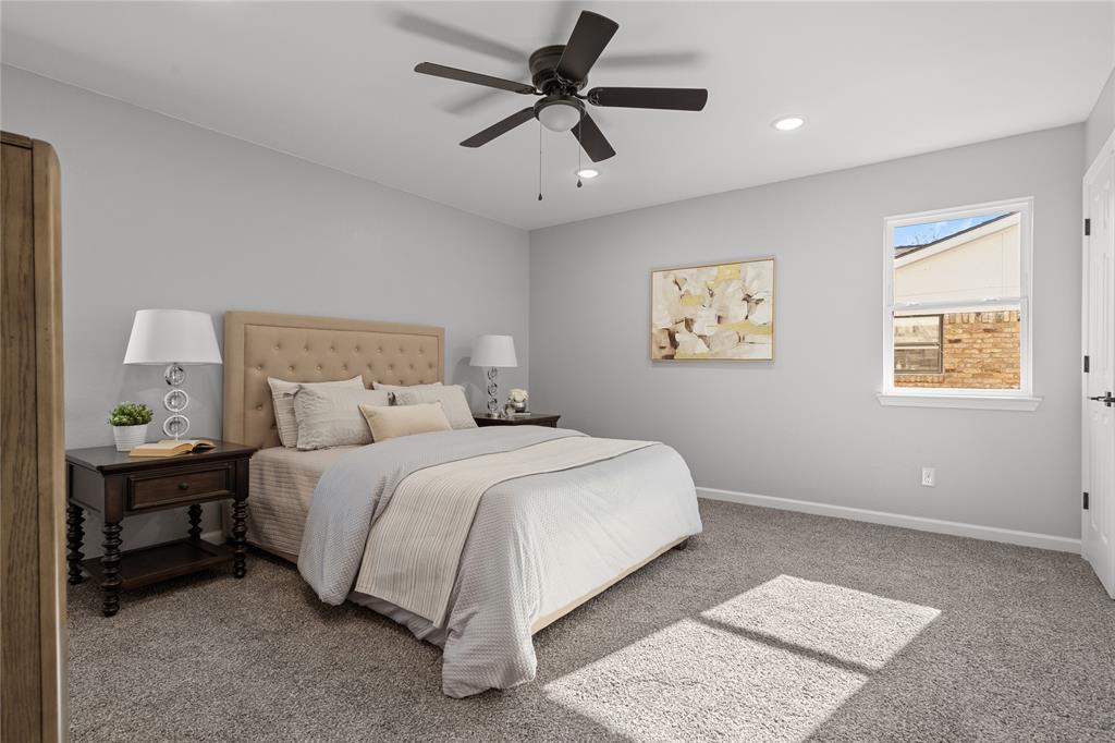 2602 Taylor Street Commerce, TX 75428 - Photo 21 of 37 a bedroom with a bed and a chandelier