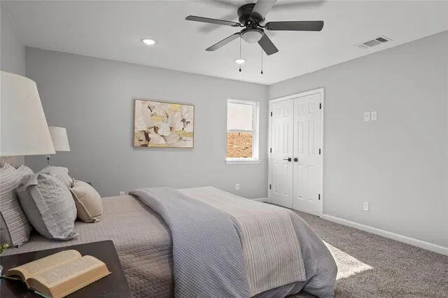 a bedroom with a large bed and a chandelier