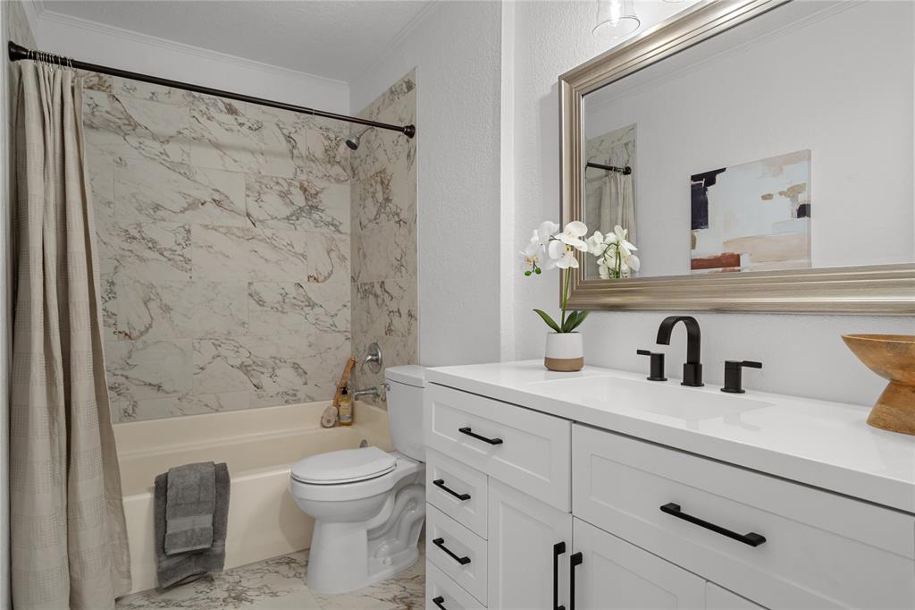 2602 Taylor Street Commerce, TX 75428 - Photo 26 of 37 a bathroom with a granite countertop sink a toilet and a mirror
