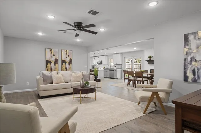a living room with furniture and kitchen view