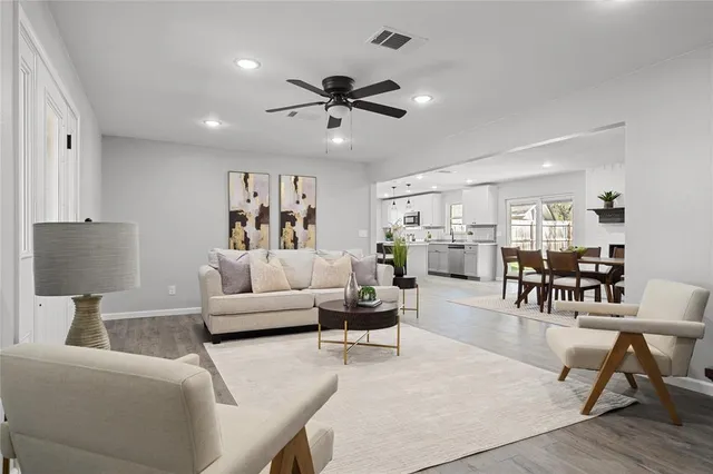 a living room with furniture and wooden floor