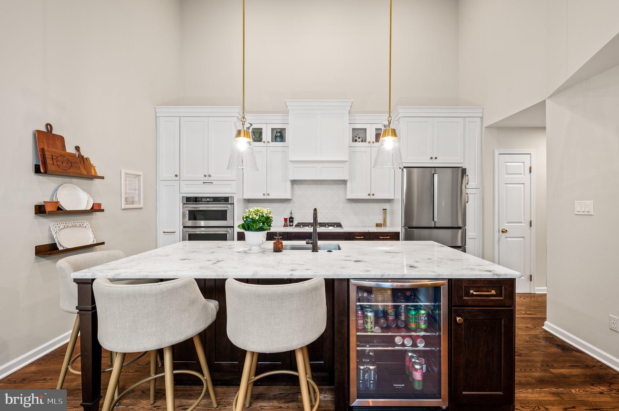 313 Heritage Place Devon, PA 19333 - Photo 16 of 44 a view of kitchen with stainless steel appliances kitchen island granite countertop a dining table chairs and white cabinets