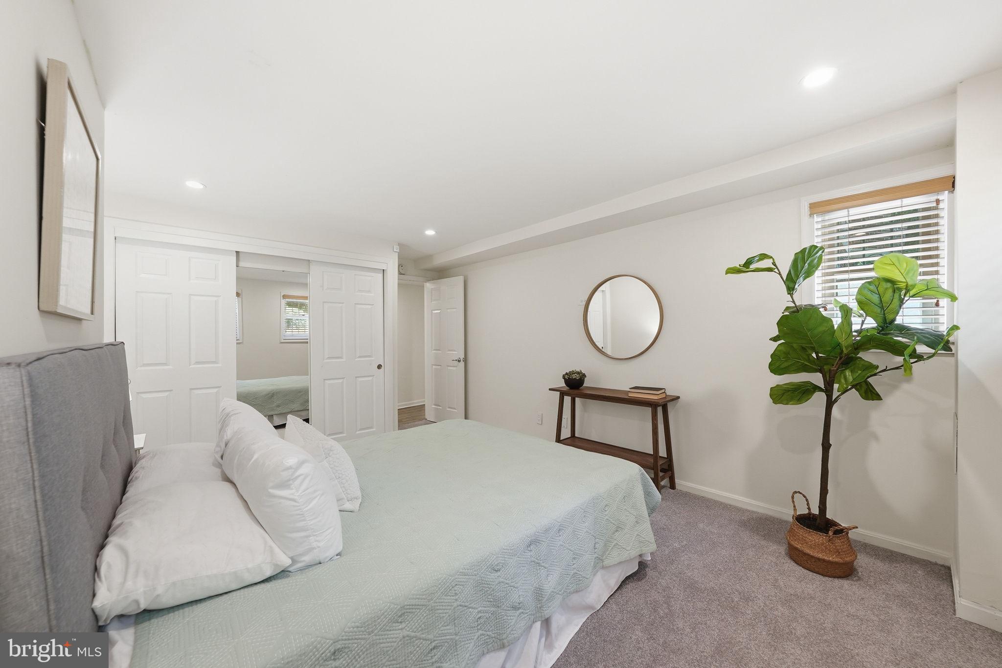 1200 East Capitol Street Northeast, Unit 1 Washington, DC 20002 - Photo 21 of 31 a bedroom with a bed and a chandelier