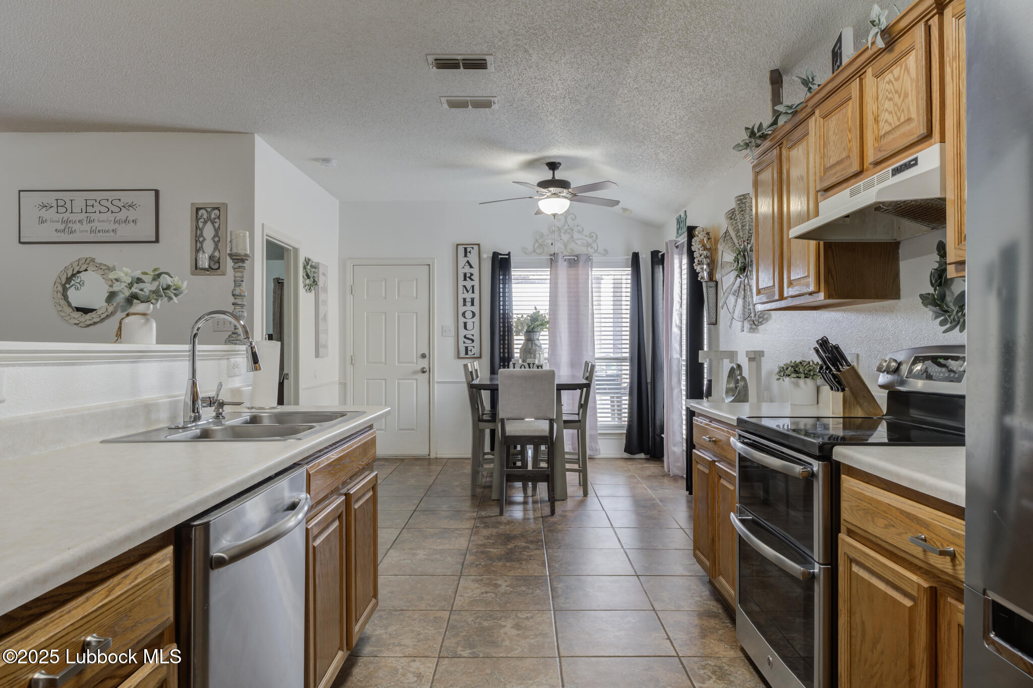 6223 18th Street Lubbock, TX 79416 - Photo 15 of 29 a kitchen with granite countertop a sink stainless steel appliances and cabinets
