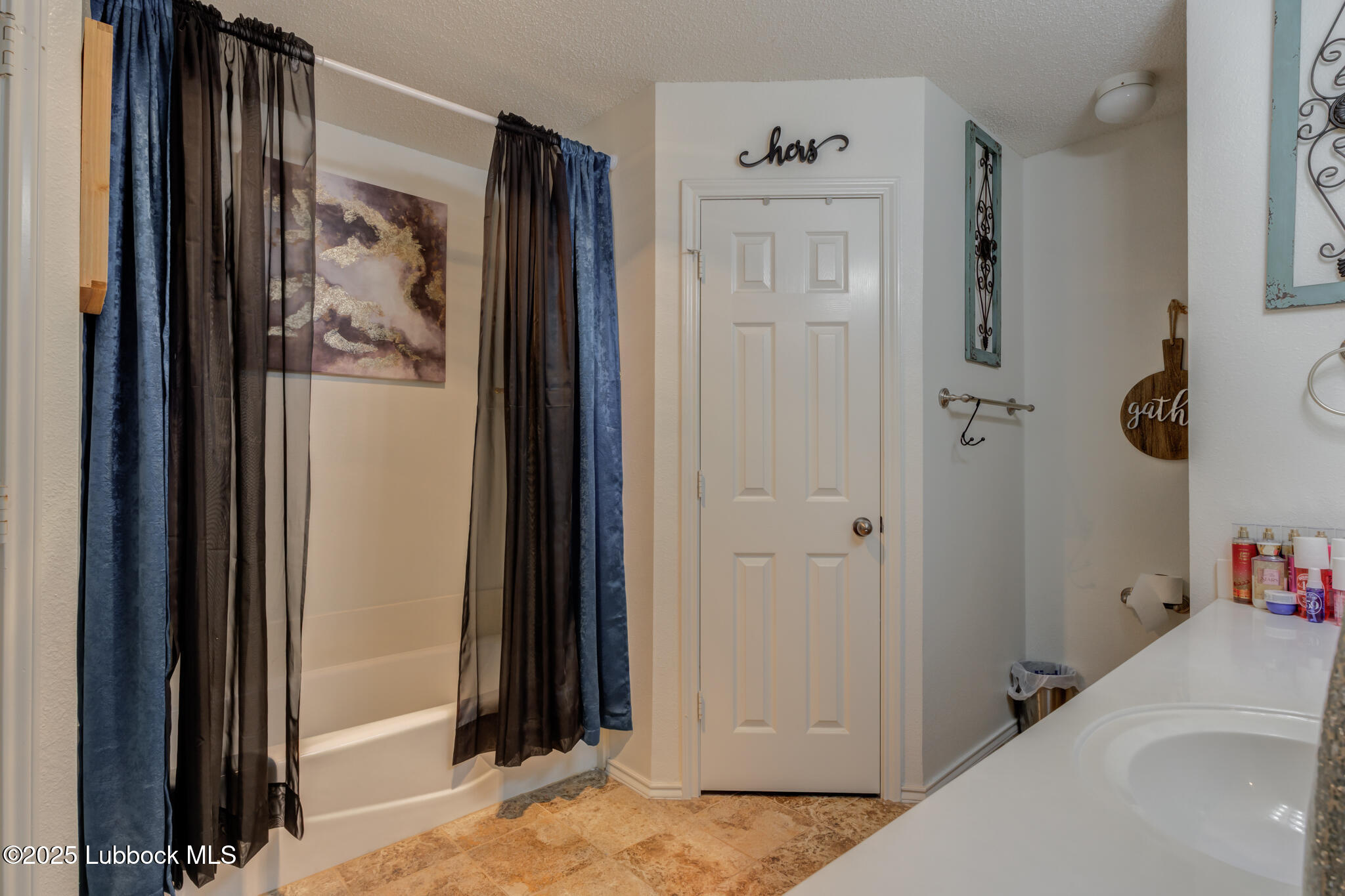 6223 18th Street Lubbock, TX 79416 - Photo 18 of 29 a view of a hallway with shelves and closet