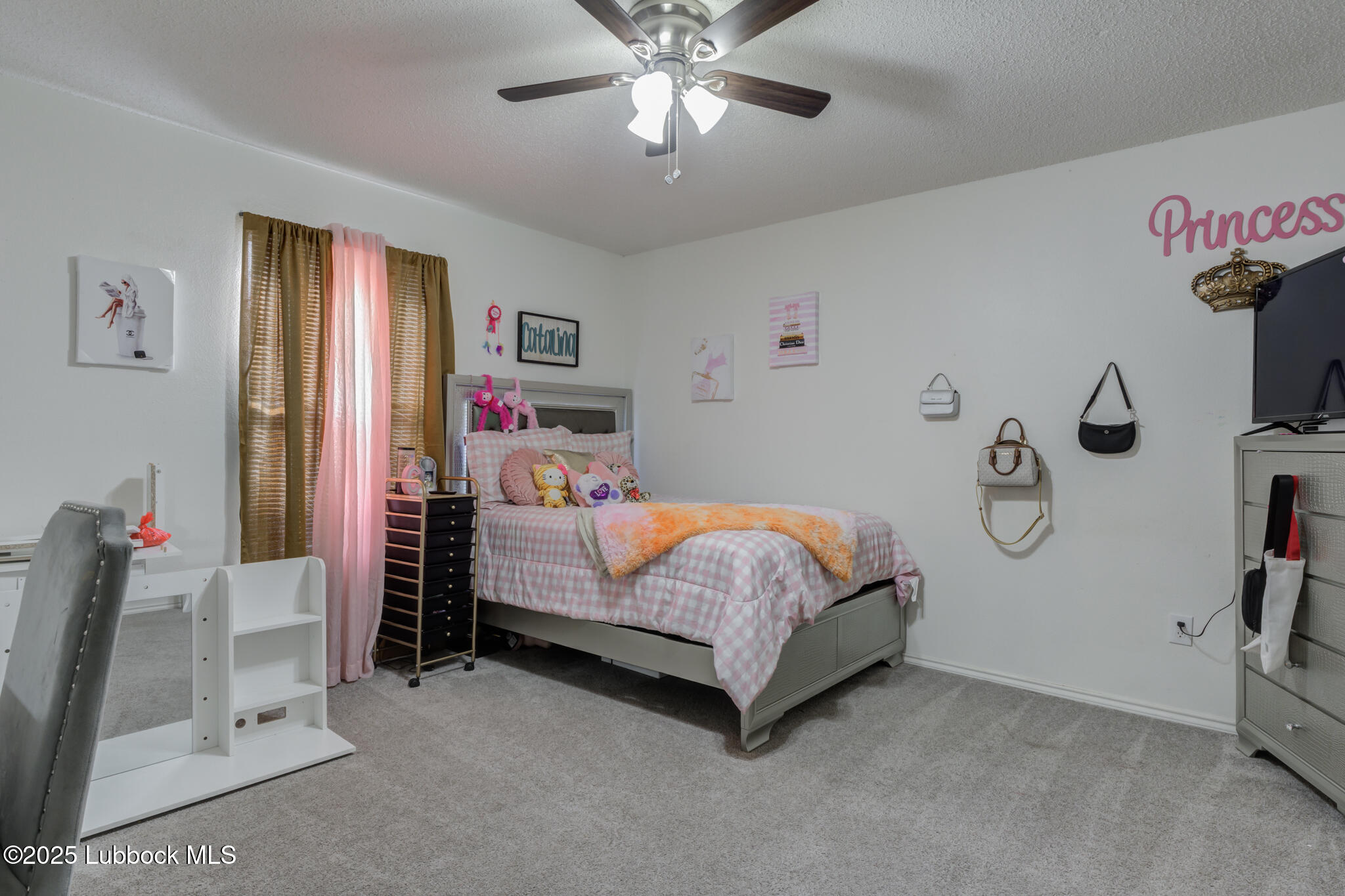 6223 18th Street Lubbock, TX 79416 - Photo 21 of 29 a bedroom with a bed and a chandelier