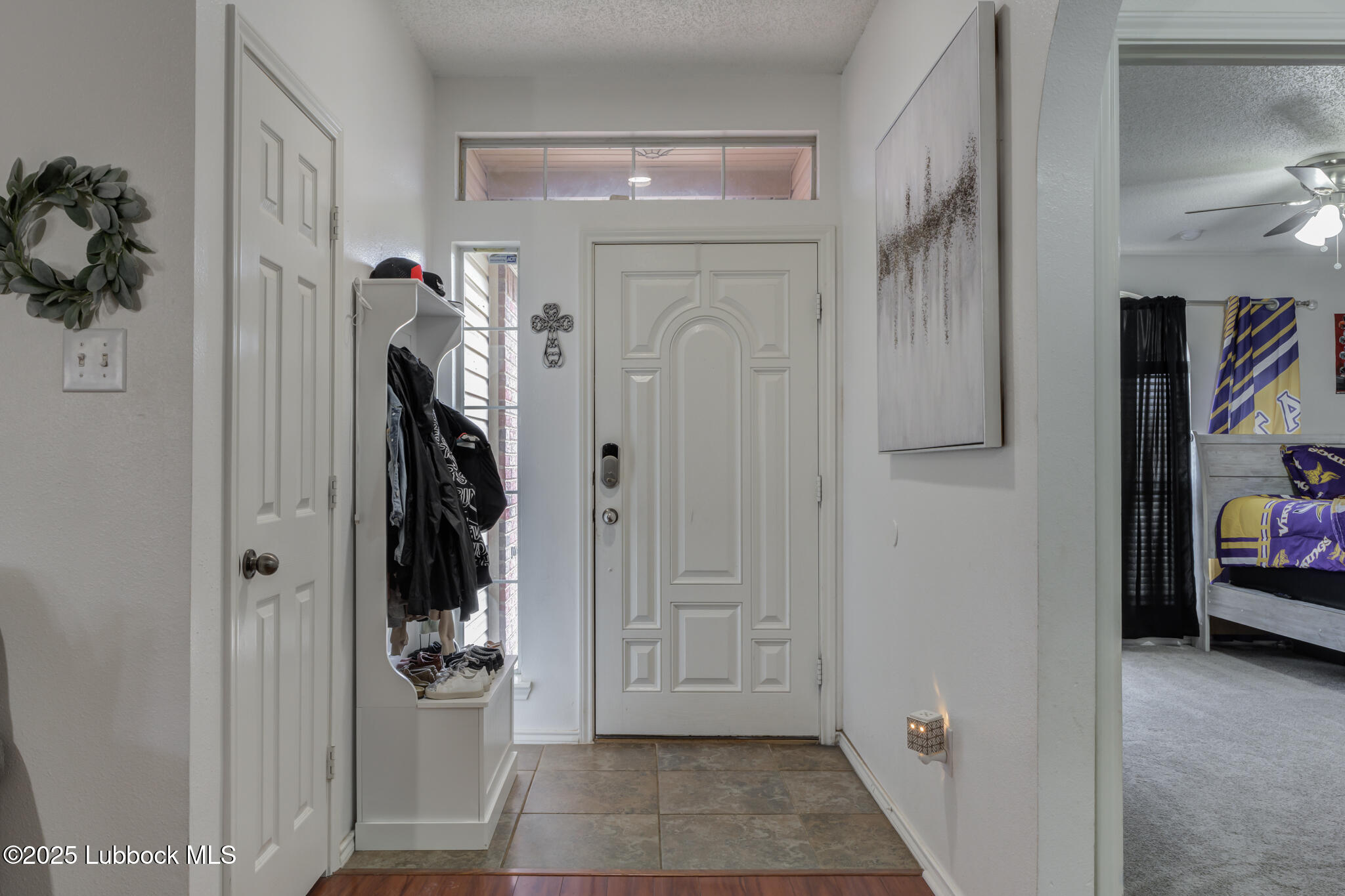 6223 18th Street Lubbock, TX 79416 - Photo 3 of 29 a view of a hallway with closet and a bathroom