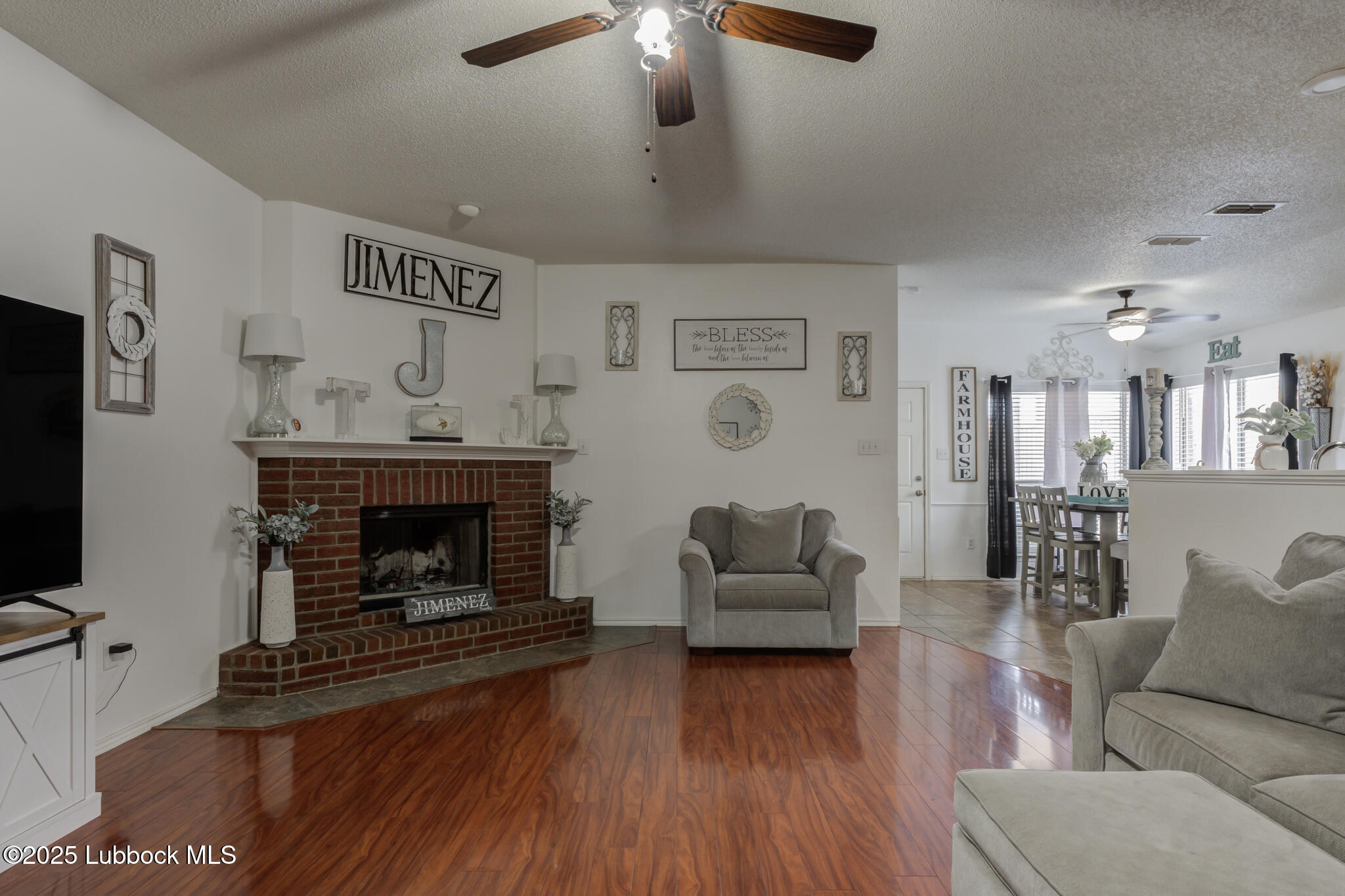 6223 18th Street Lubbock, TX 79416 - Photo 4 of 29 a living room with furniture and a fireplace