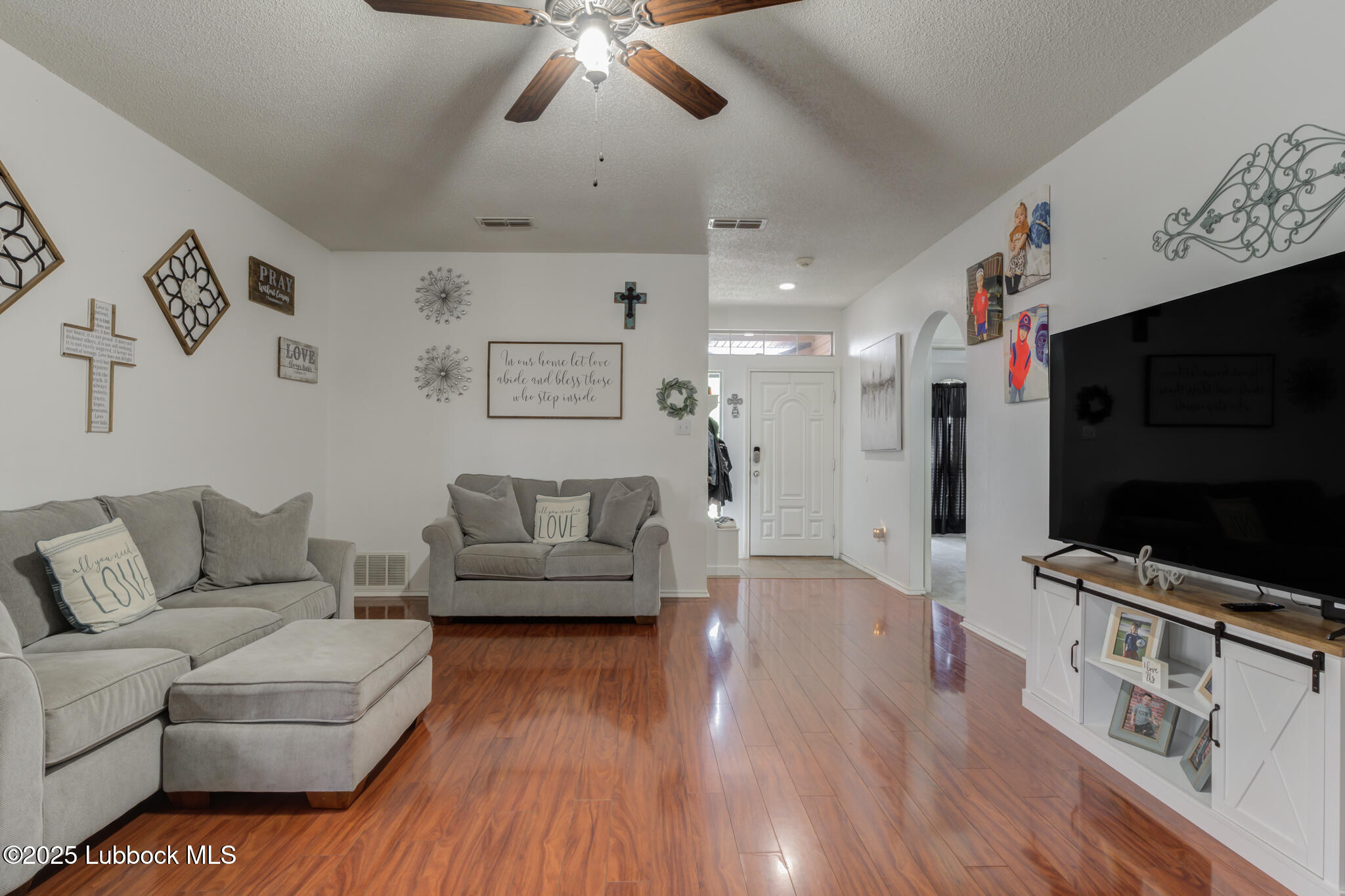 6223 18th Street Lubbock, TX 79416 - Photo 8 of 29 a living room with furniture and a flat screen tv