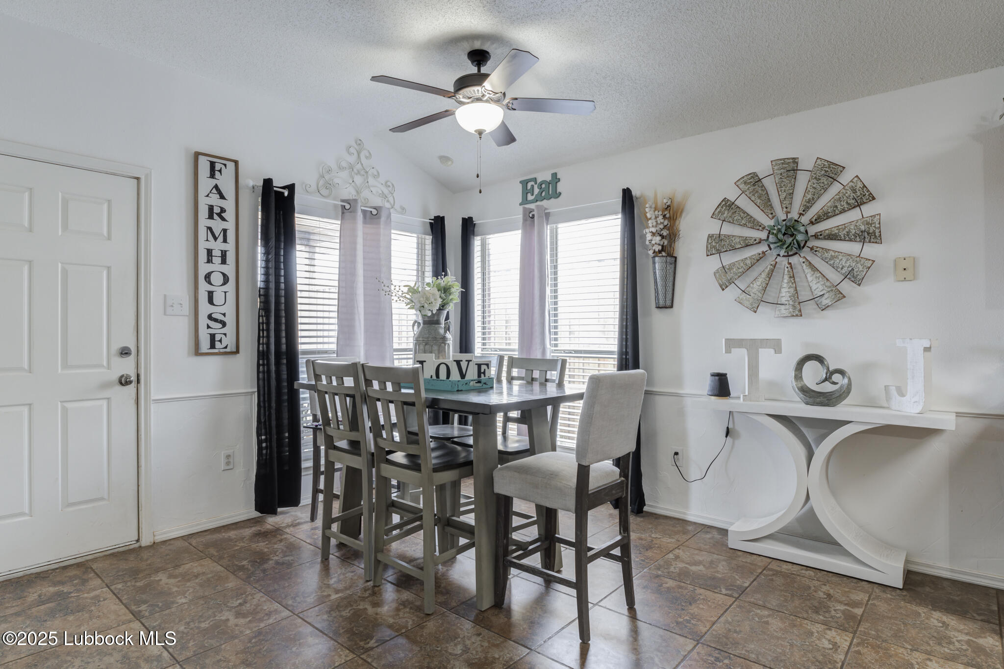 6223 18th Street Lubbock, TX 79416 - Photo 9 of 29 a view of a a dining room with furniture window and wooden floor