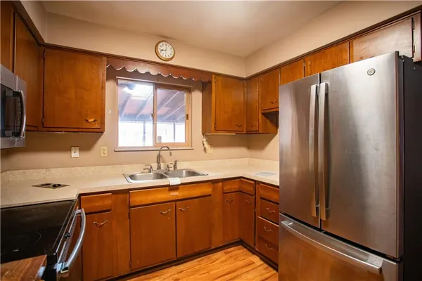 a kitchen with stainless steel appliances granite countertop a refrigerator and a sink