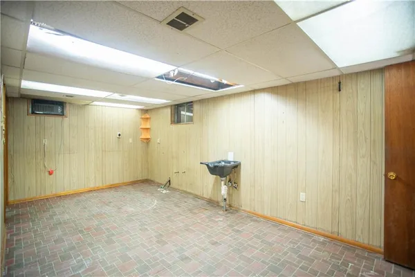 a view of a hallway with wooden shelves
