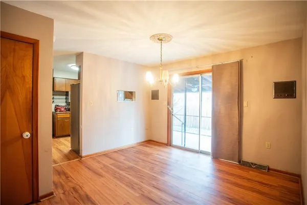 a view of a room with wooden floor and windows