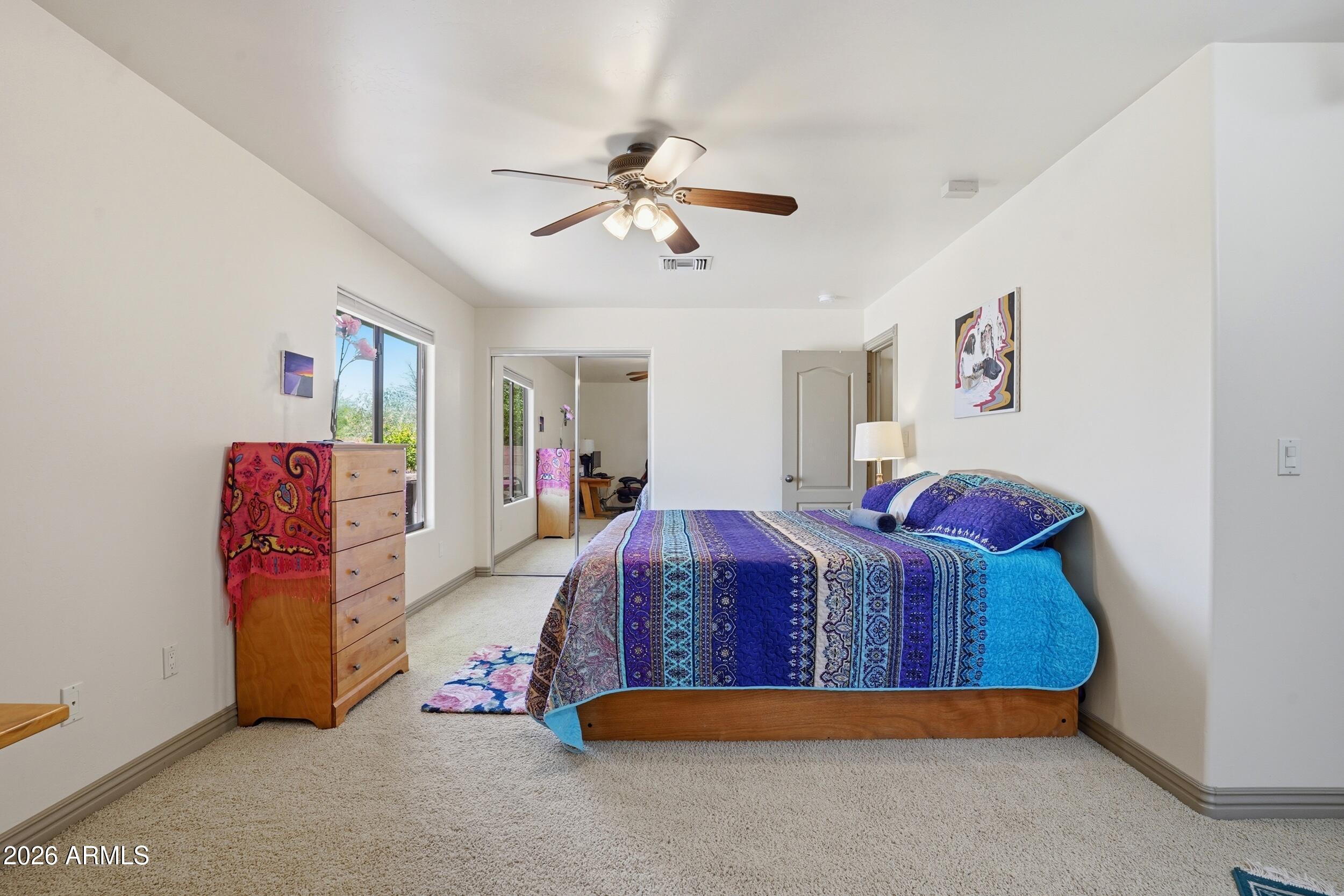 6334 East Albany Street Mesa, AZ 85205 - Photo 41 of 72 a bedroom with a bed and a chandelier