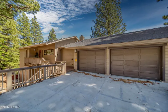 a view of a house with a small yard and wooden fence