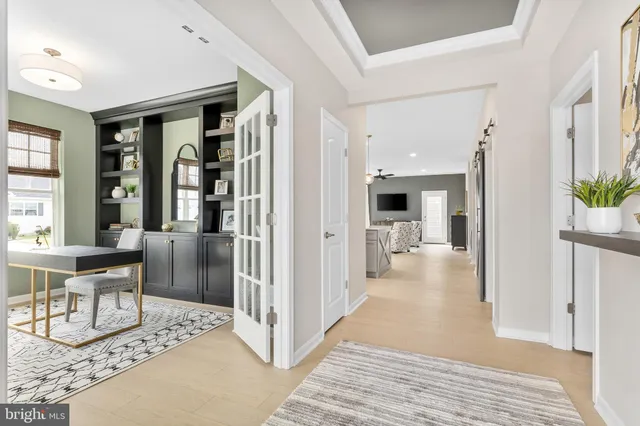 a view of a livingroom and a dining room with wooden floor and a rug