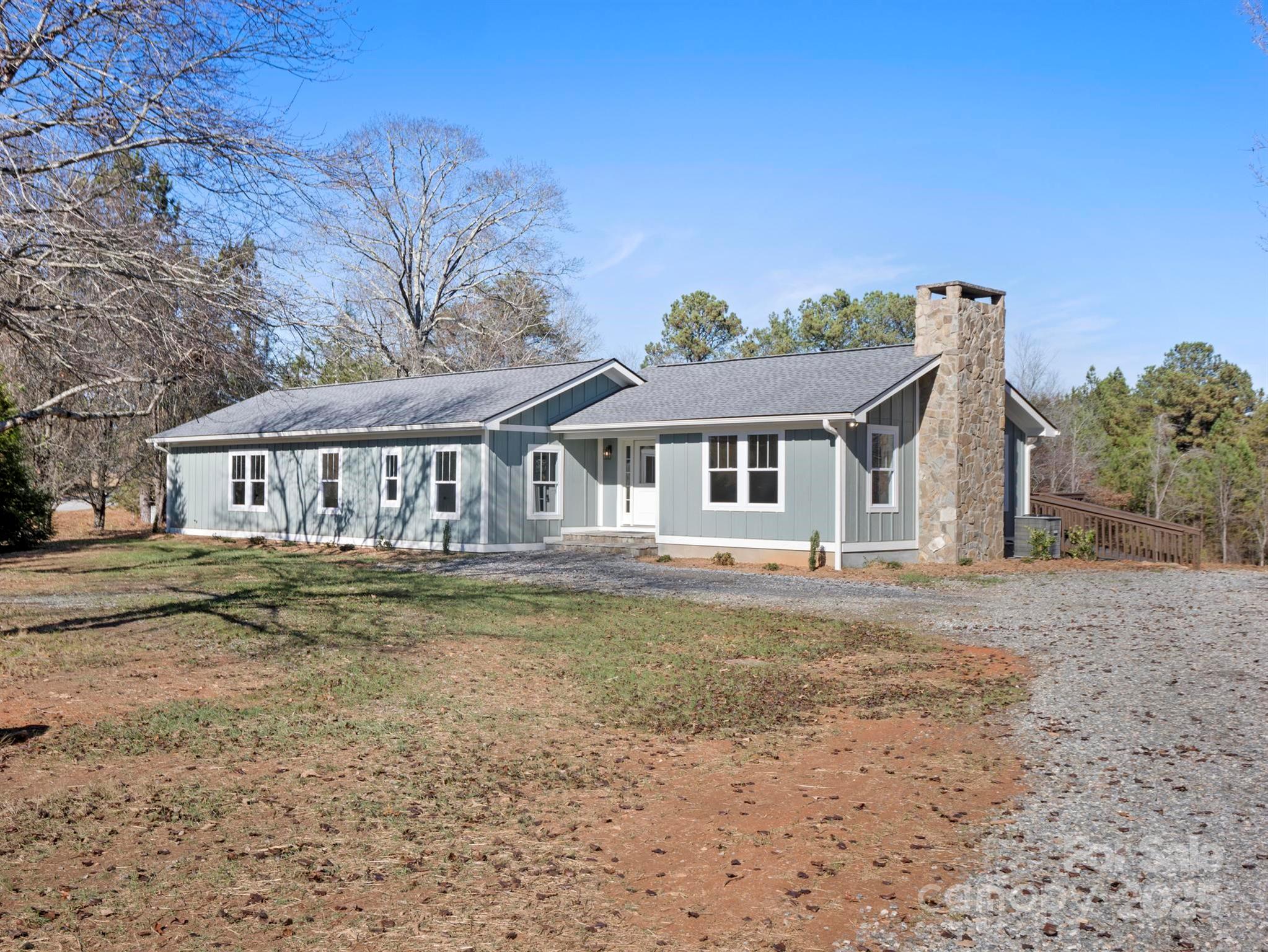 a view of a house with a yard and sitting area