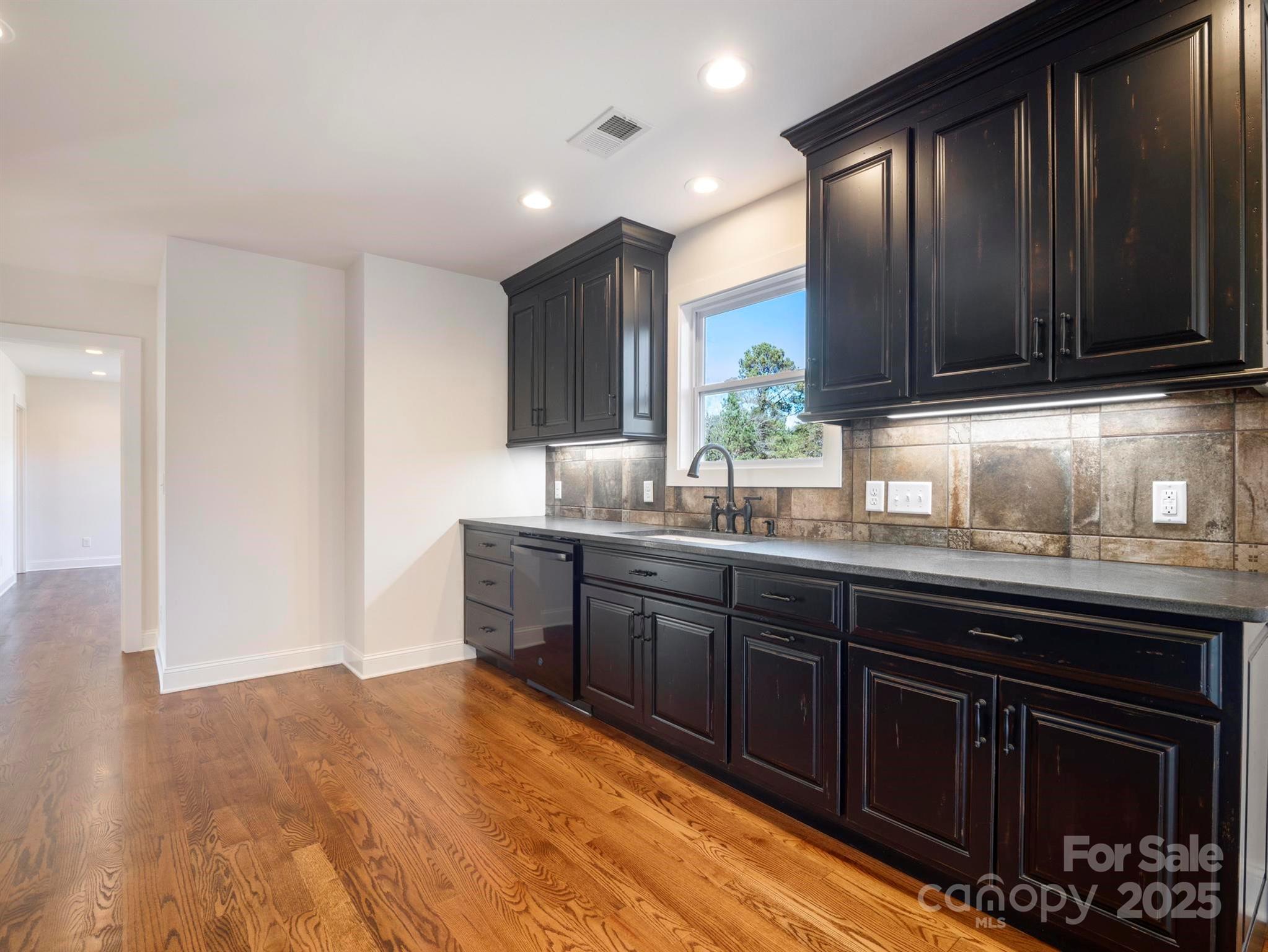 100 Gilbert Road Columbus, NC 28722 - Photo 11 of 24 a kitchen with granite countertop a sink cabinets and stainless steel appliances