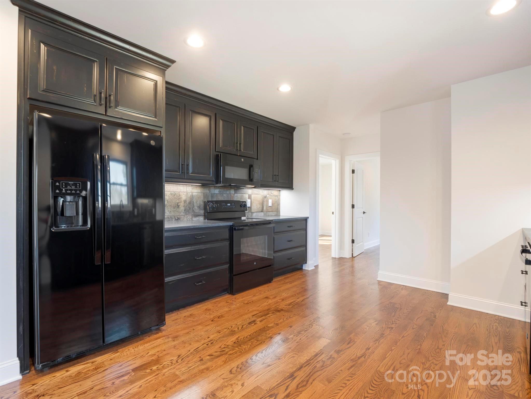 100 Gilbert Road Columbus, NC 28722 - Photo 12 of 24 a kitchen with granite countertop stainless steel appliances and refrigerator