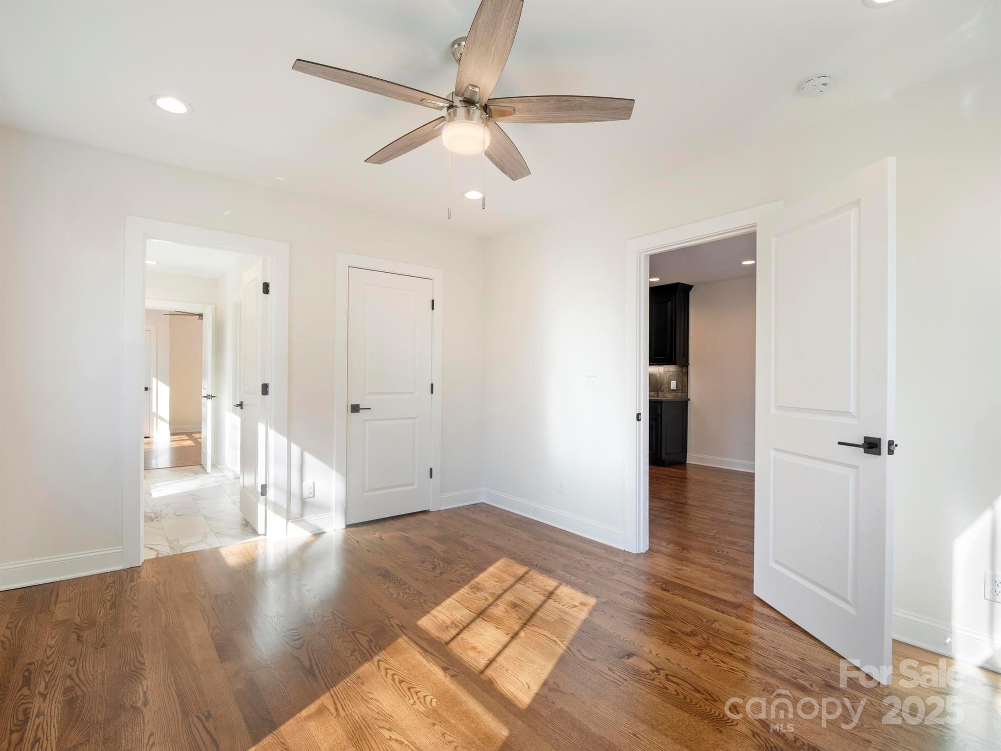 100 Gilbert Road Columbus, NC 28722 - Photo 14 of 24 a view of an empty room with wooden floor and a ceiling fan