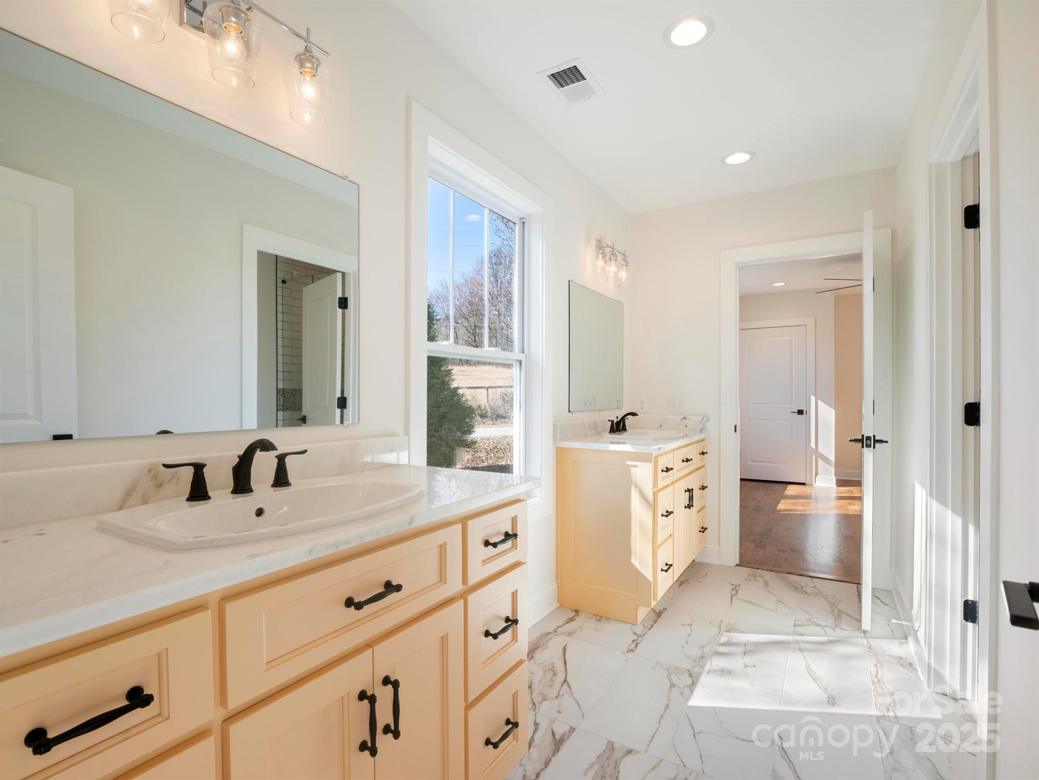 100 Gilbert Road Columbus, NC 28722 - Photo 15 of 24 a spacious bathroom with a double vanity sink toilet and shower