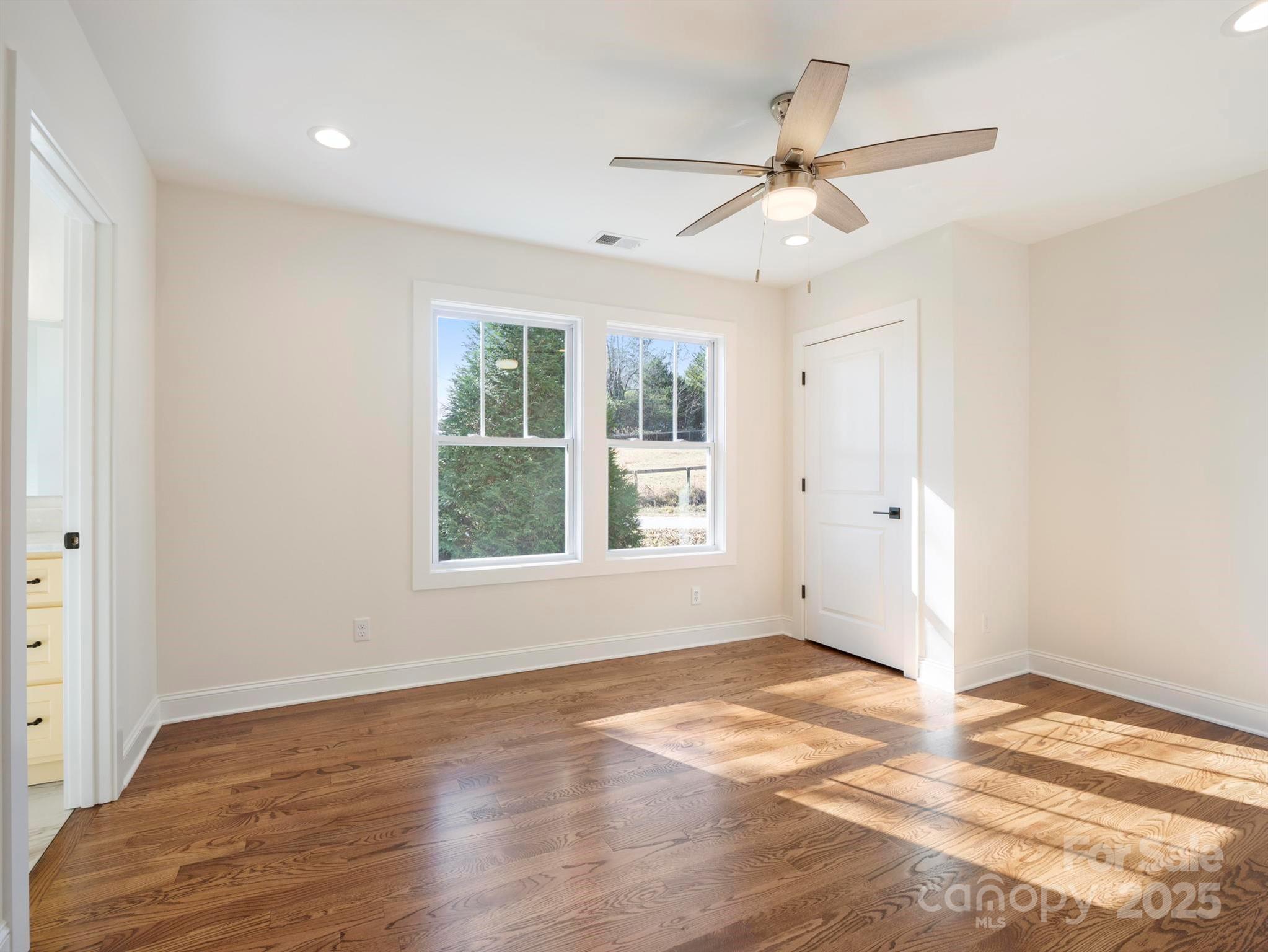 100 Gilbert Road Columbus, NC 28722 - Photo 18 of 24 wooden floor in an empty room with a window