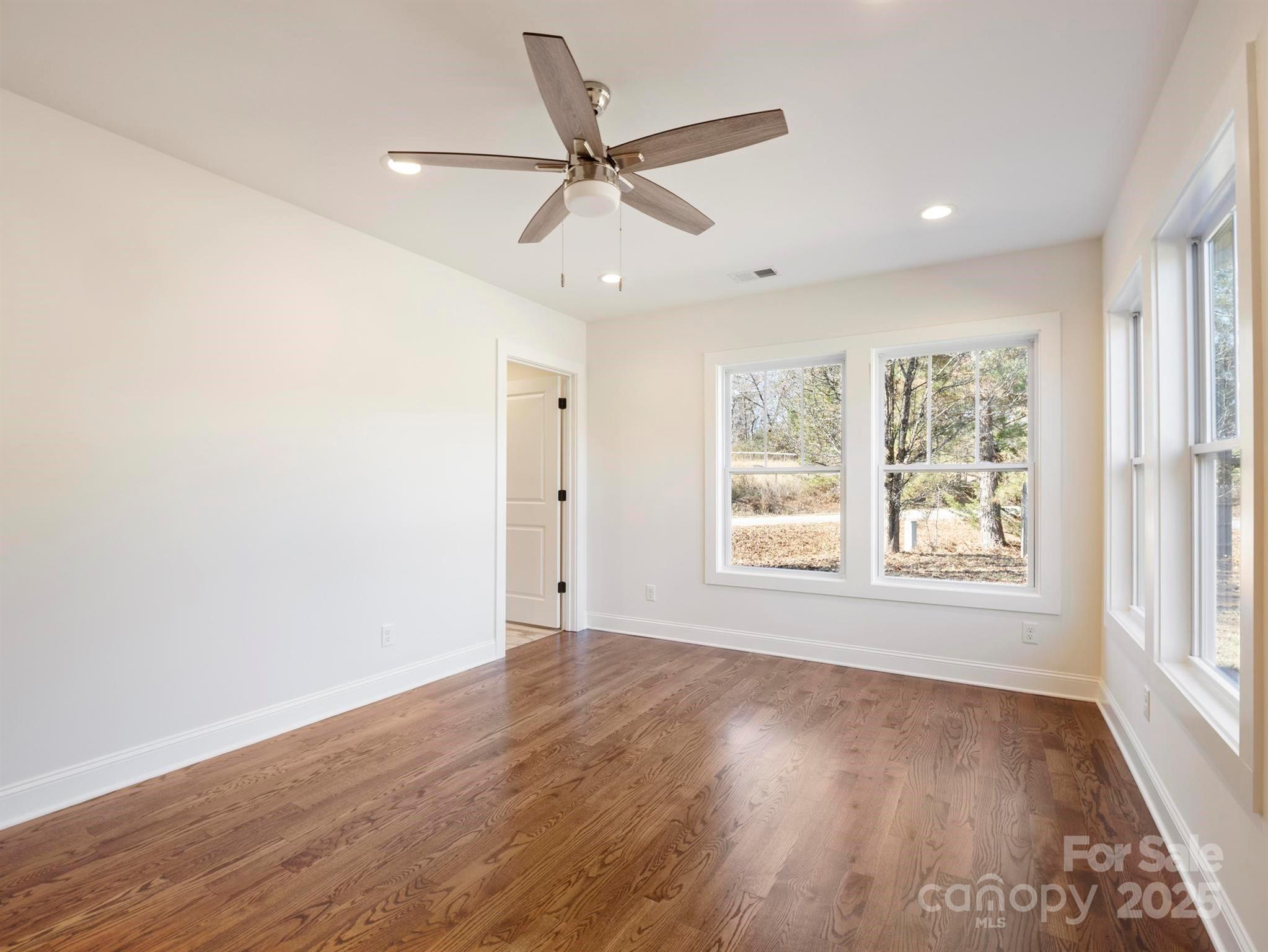 100 Gilbert Road Columbus, NC 28722 - Photo 20 of 24 a view of an empty room with wooden floor and a window