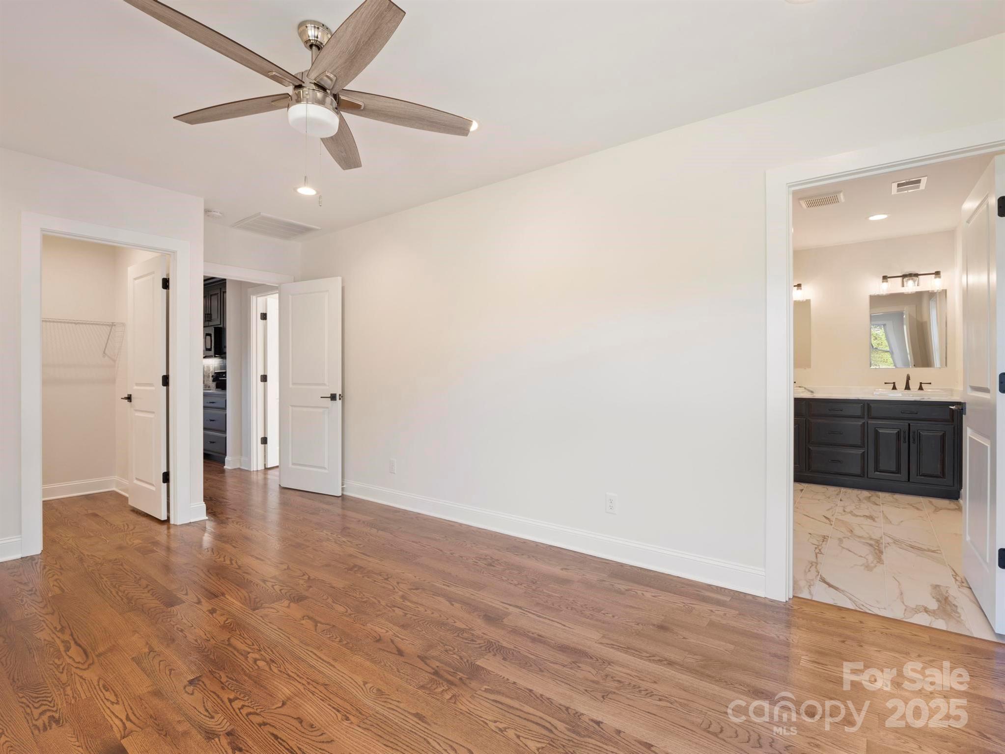 100 Gilbert Road Columbus, NC 28722 - Photo 21 of 24 a view of a big room with wooden floor and a ceiling fan