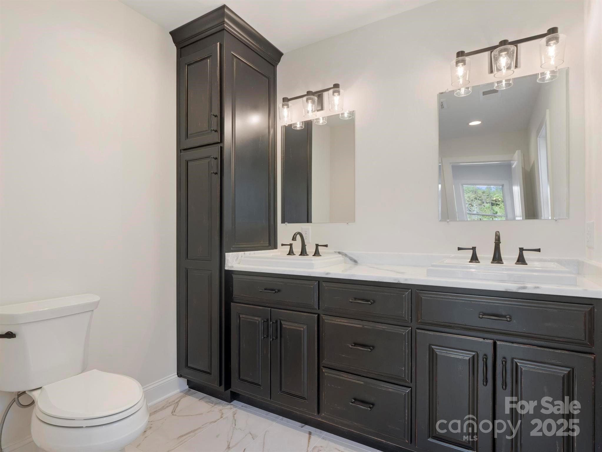 100 Gilbert Road Columbus, NC 28722 - Photo 23 of 24 a bathroom with a double vanity sink toilet and mirror