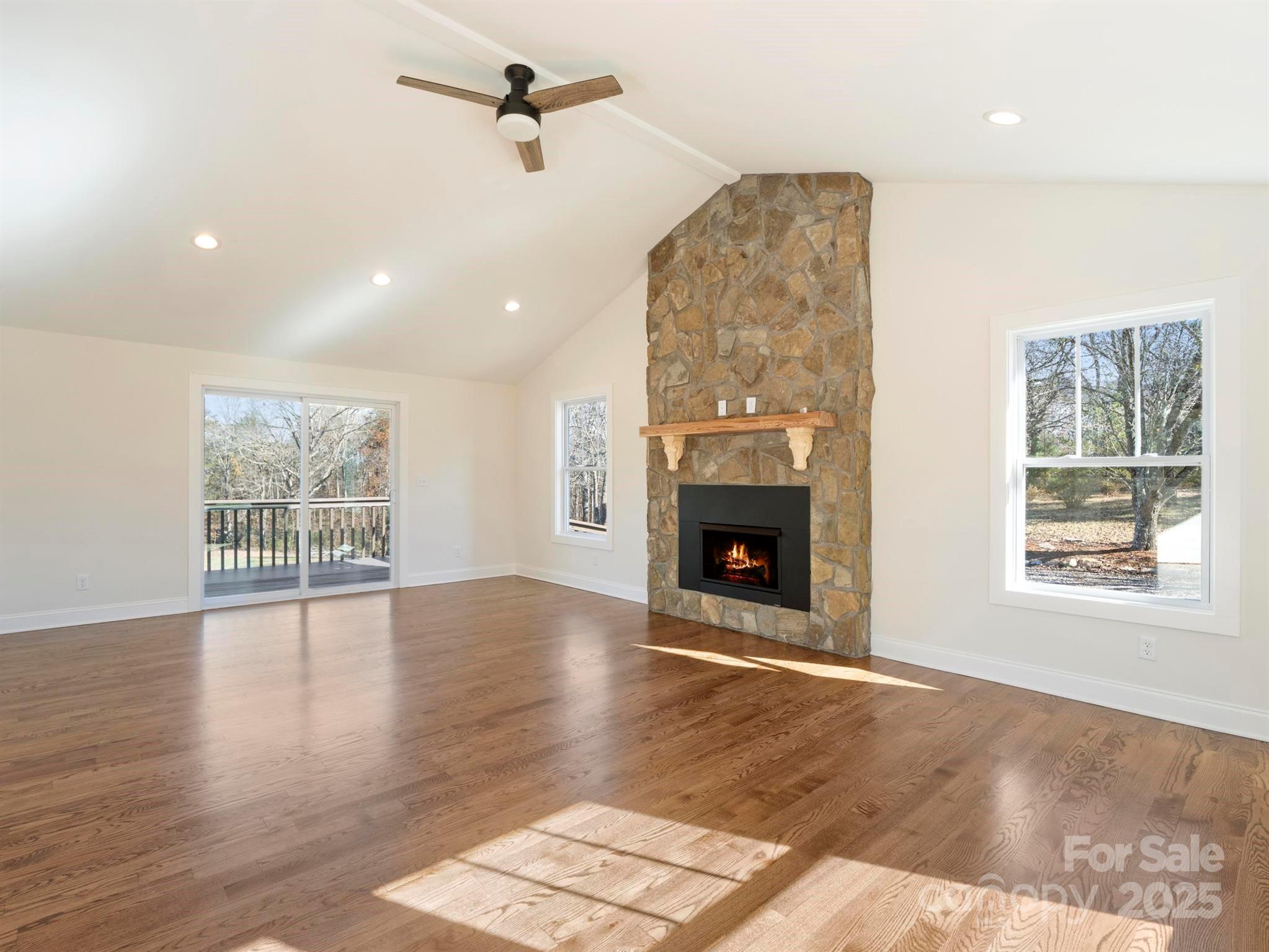 100 Gilbert Road Columbus, NC 28722 - Photo 6 of 24 an empty room with windows and fireplace