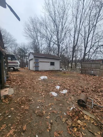 a view of a yard with large trees