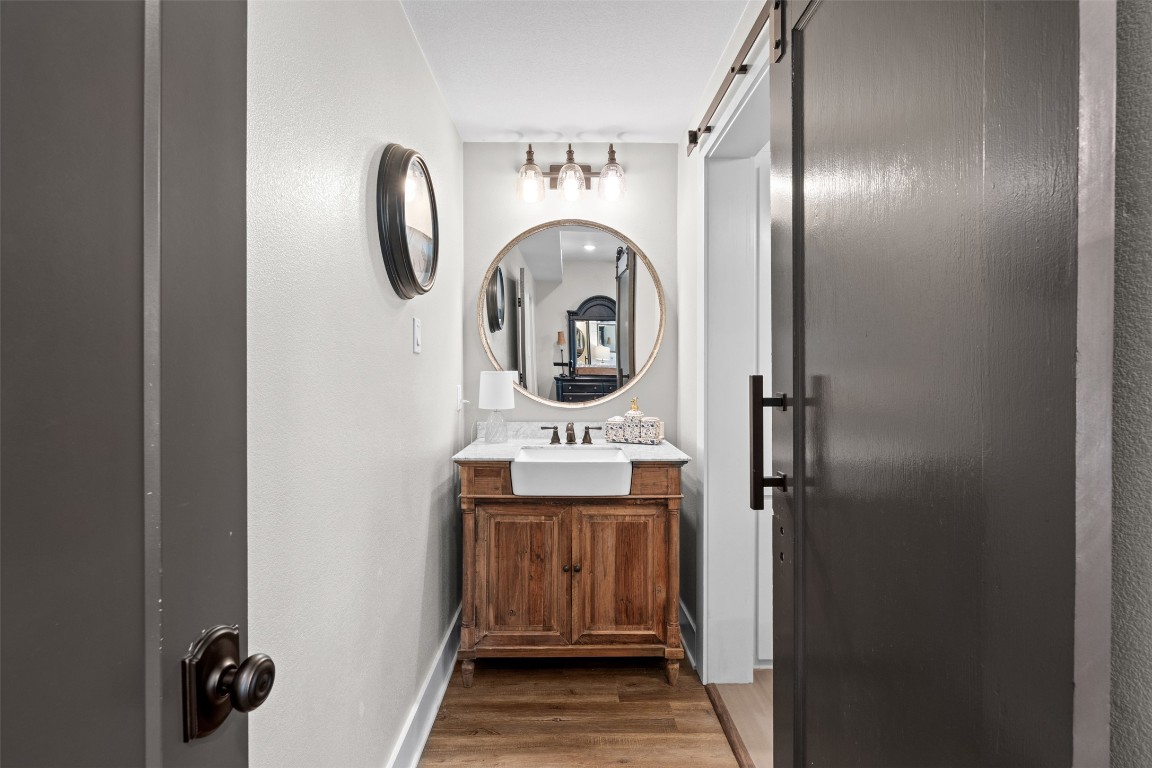 1005 East 14th Street Cameron, TX 76520 - Photo 26 of 40 a bathroom with a sink and a mirror