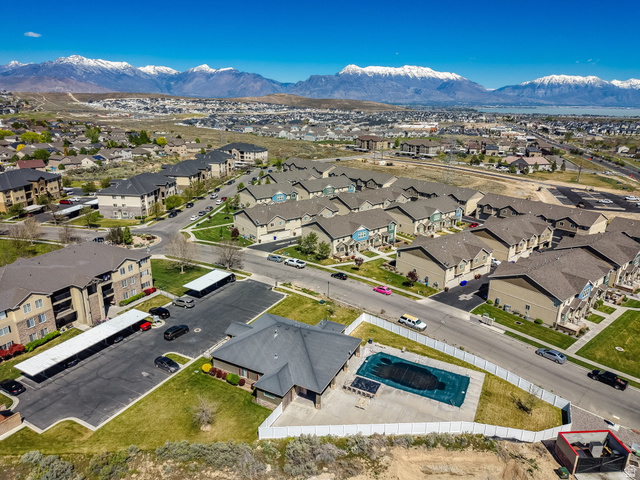 8215 Clear Rock Road, Unit 12 Eagle Mountain, UT 84005 - Photo 22 of 38 Aerial perspective showcasing a residential community with snow-capped mountains in the background
