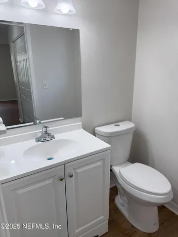 a bathroom with a sink a toilet and mirror