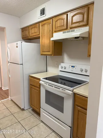 a kitchen with a stove and a refrigerator
