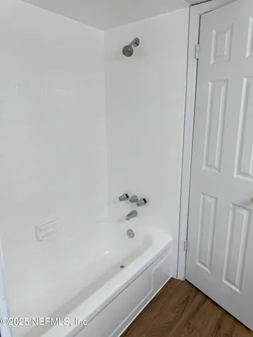 a bathroom with bathtub and shower