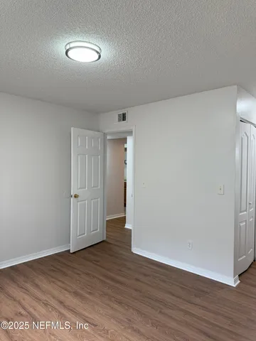 a view of an empty room and wooden floor