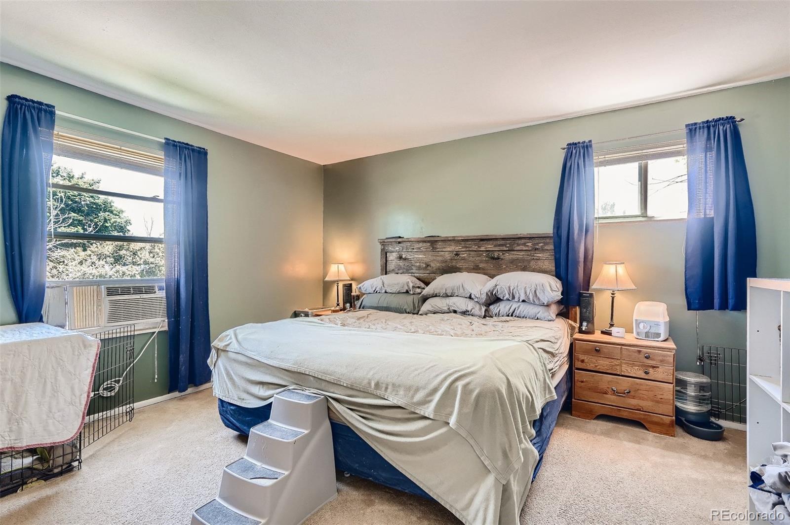 10541 Routt Street Westminster, CO 80021 - Photo 11 of 26 a bedroom with a bed and wooden floor