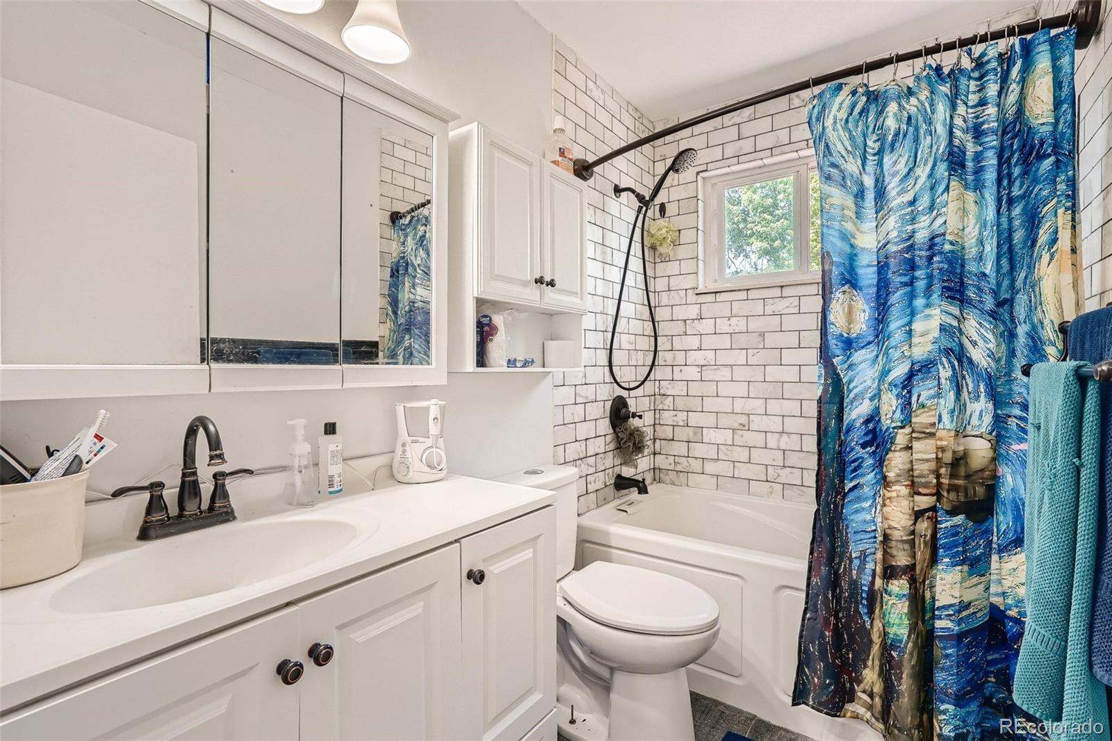 10541 Routt Street Westminster, CO 80021 - Photo 13 of 26 a bathroom with a sink toilet and shower