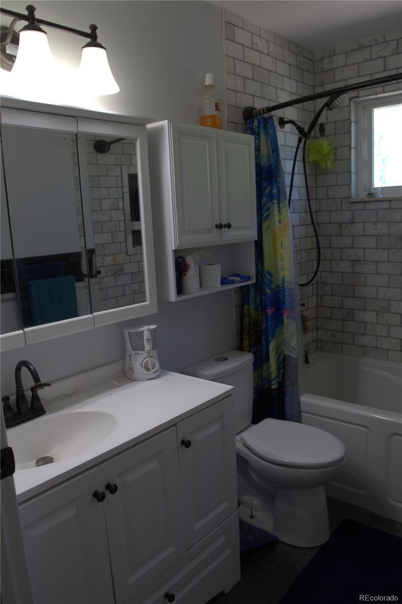 10541 Routt Street Westminster, CO 80021 - Photo 14 of 26 a bathroom with a sink toilet and shower
