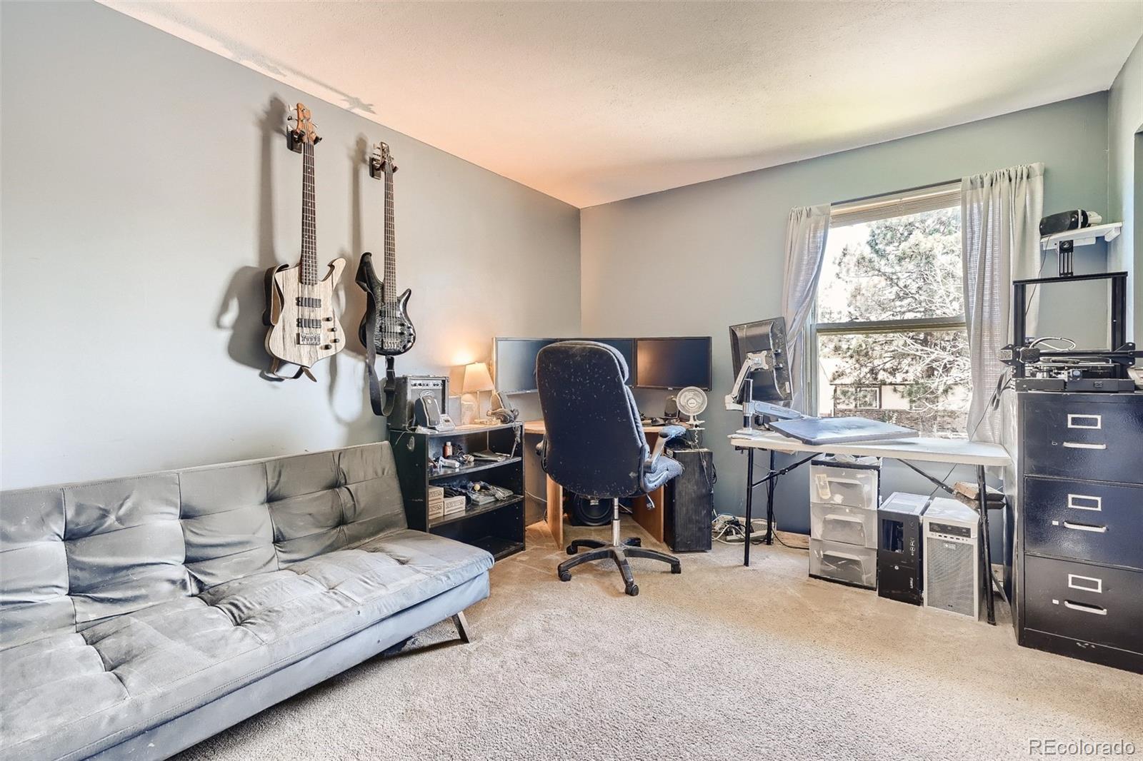 10541 Routt Street Westminster, CO 80021 - Photo 17 of 26 a view of a workspace with furniture and a window