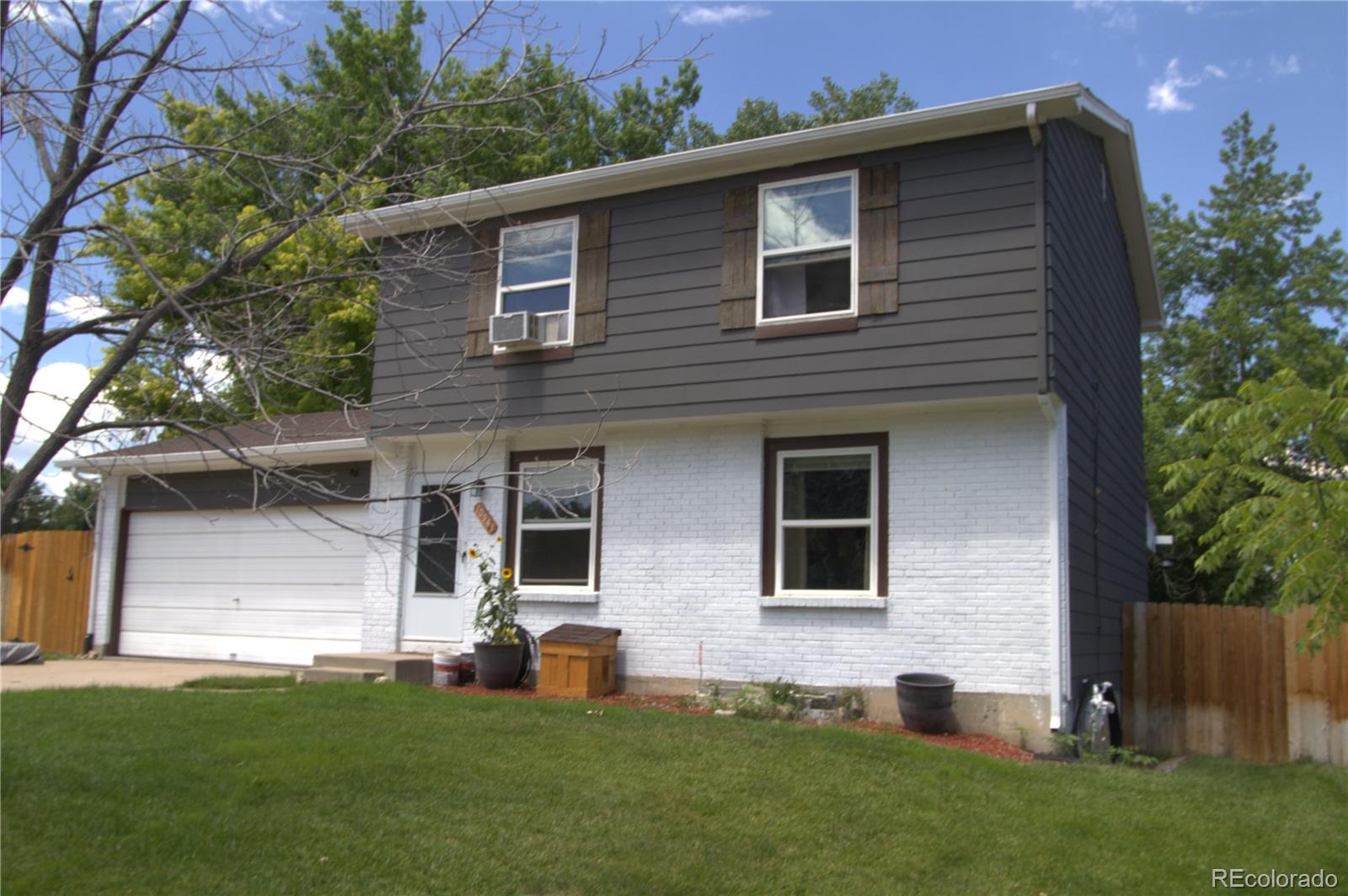 10541 Routt Street Westminster, CO 80021 - Photo 2 of 26 a front view of a house with a yard