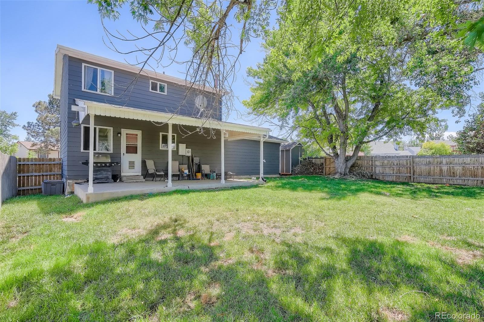 10541 Routt Street Westminster, CO 80021 - Photo 22 of 26 front view of a brick house with a yard