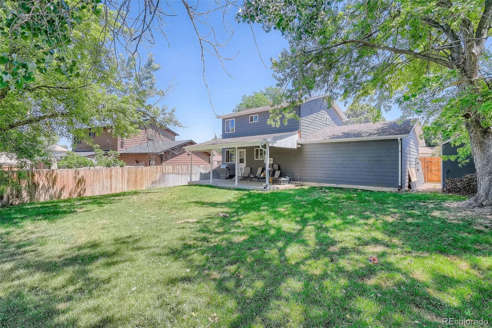 10541 Routt Street Westminster, CO 80021 - Photo 23 of 26 a view of a house with a yard