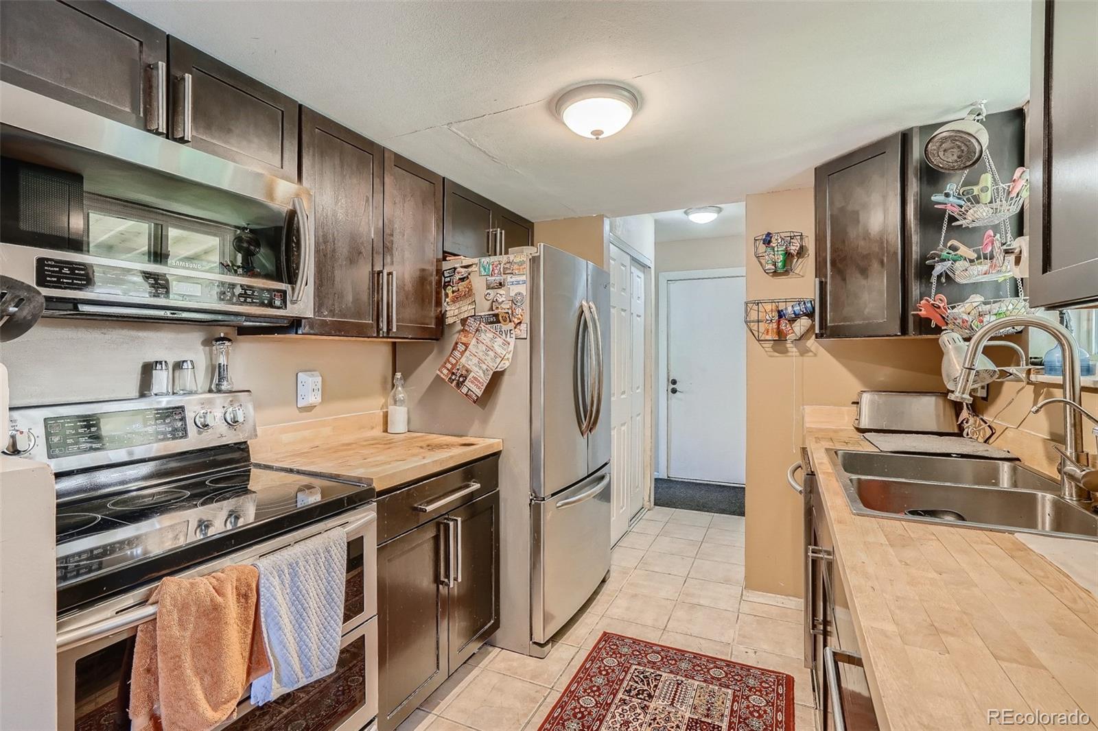 10541 Routt Street Westminster, CO 80021 - Photo 6 of 26 a kitchen with stainless steel appliances granite countertop a refrigerator and a stove