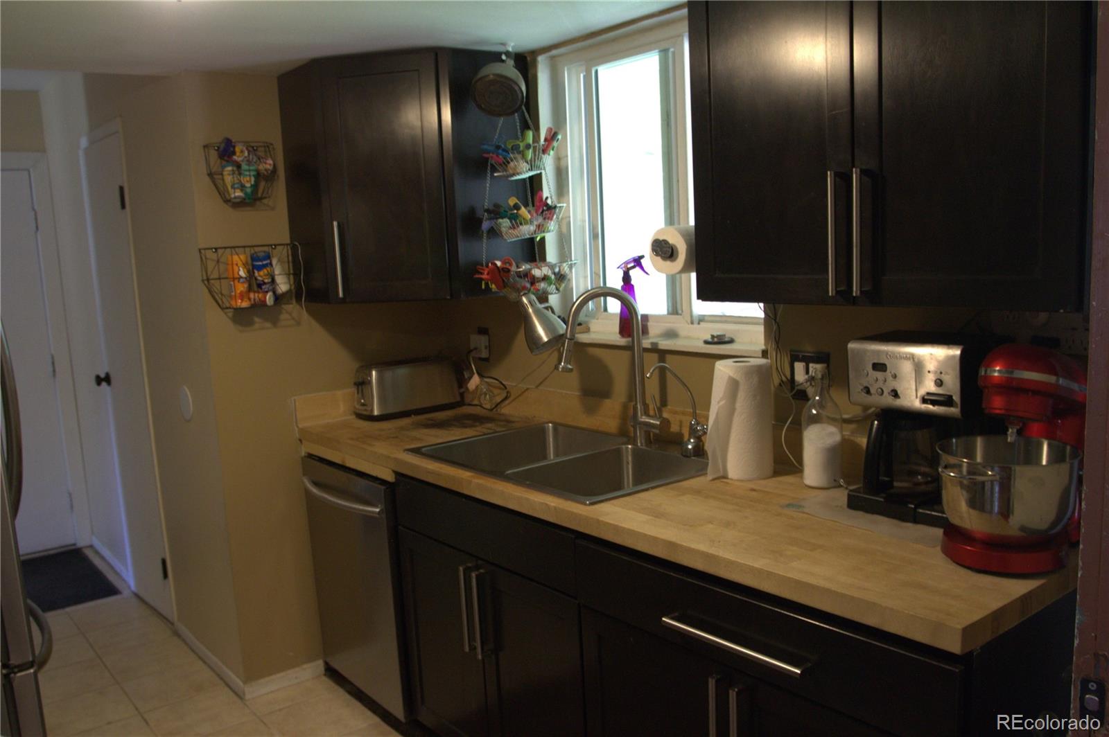 10541 Routt Street Westminster, CO 80021 - Photo 8 of 26 a kitchen with sink and refrigerator