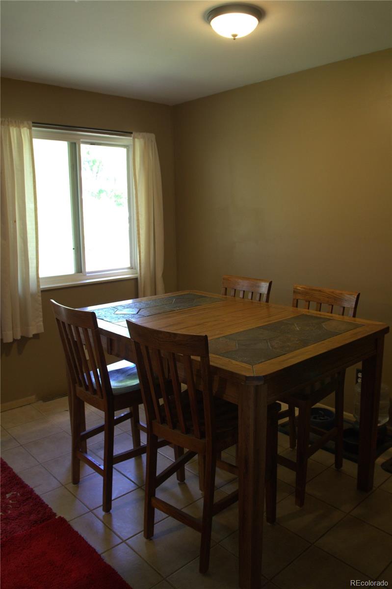 10541 Routt Street Westminster, CO 80021 - Photo 9 of 26 a view of a dining room with furniture and window