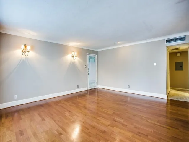 a view of an empty room and wooden floor
